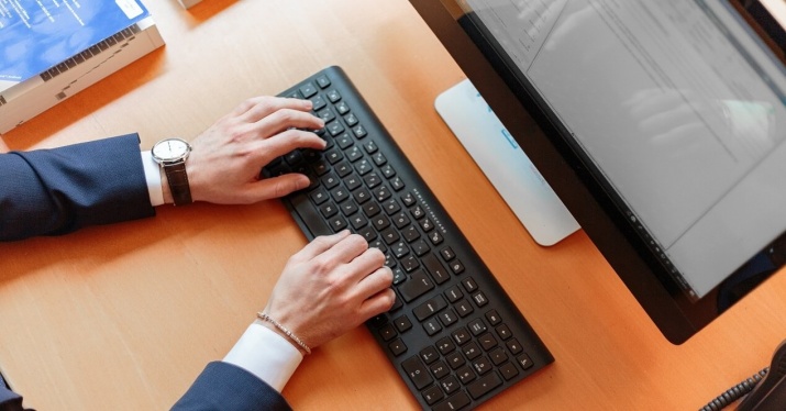 hands typing on a keyboard